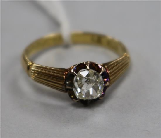 A 20th century 18ct gold and claw set solitaire diamond ring with reeded shoulders, size K.